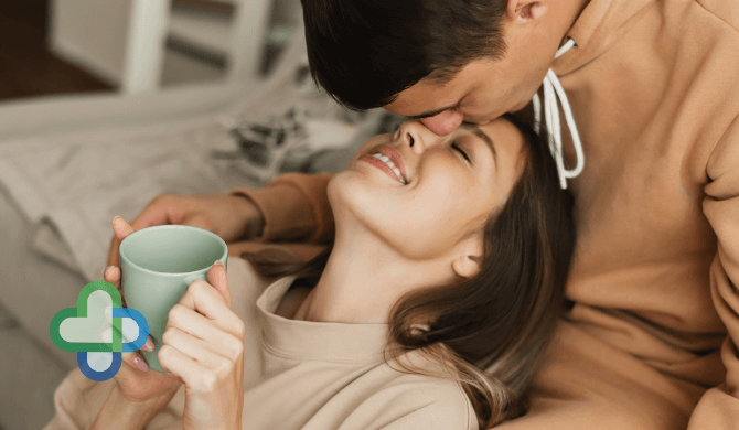 man kissing woman s forehead in bed - buy cheap ed treatment online